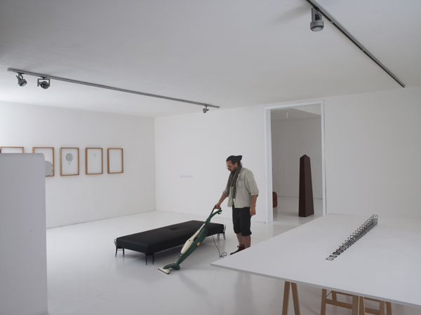 Gilad vacuuming at Dilmos, 2012. Photo by Max Rommel