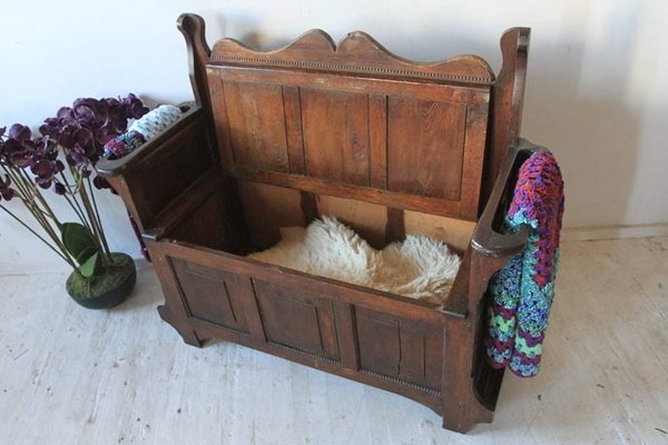 Antique bench seat with storage outlet
