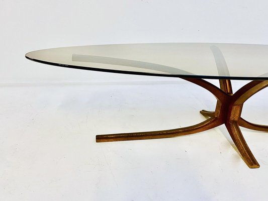 A Mid-Century Iron and Glass Oval Coffee Table A Mid-Century Iron and Glass Oval Coffee Table