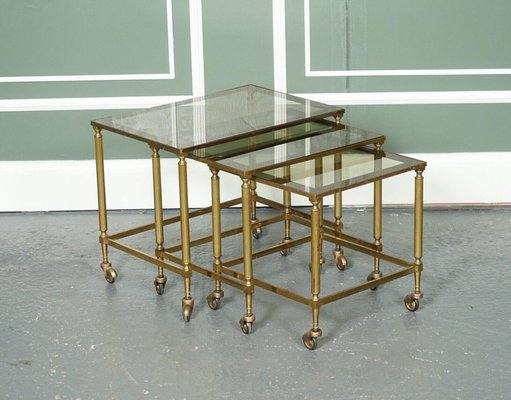 https://cdn20.pamono.com/p/g/1/3/1373243_nm7a917oi3/vintage-hollywood-regency-brass-glass-nest-of-tables-1950s-set-of-3-1.jpg