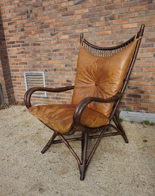 https://cdn20.pamono.com/p/g/1/4/1445070_qy0vcm1cap/bamboo-and-leather-sculptural-fan-back-lounge-chair-1960s-1.jpg
