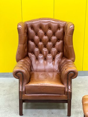 Brown leather 2024 armchair and ottoman