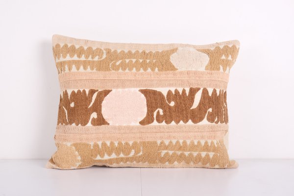 https://cdn20.pamono.com/p/g/1/5/1583049_m6ej3ppb2i/uzbek-faded-brown-samarkand-suzani-lumbar-cushion-cover-1.jpg