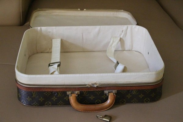 1950s Louis Vuitton suitcase, with leather strap work and canvas lined  aluminium frame, 70cm wide x