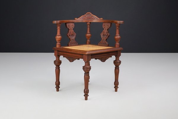 Antique German Corner Chair in Hand-Carved Walnut with Cane Seat