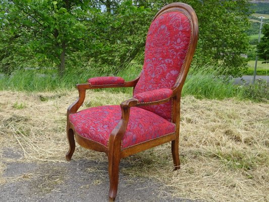 Poltrona Voltaire antica in noce e tessuto di velluto, fine XIX