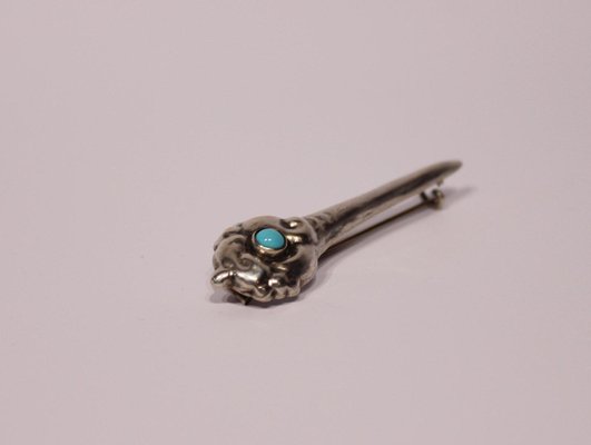 small blue brooch