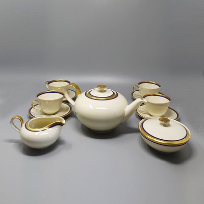 https://cdn20.pamono.com/p/g/9/6/963822_w6kkgkwwxr/german-white-blue-and-gold-porcelain-tea-set-coffee-set-1950s-set-of-11-1.jpg