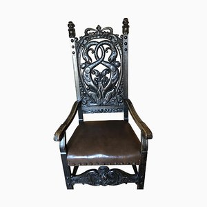 Antiker Armlehnstuhl aus Holz mit schwarzem Bezug
