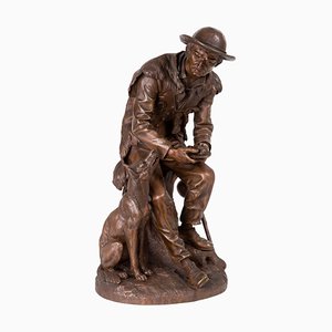 Anatole J. Guillot, Depicting Seated Woodcarver with Dog, Bronze Sculpture