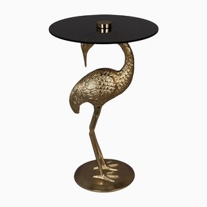Gold Colour Cast Aluminium Side Table with Black Coloured Glass Table Top and Body in Form of a Crane from Dutchbone