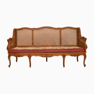 Antique French Bergere Sofa in Carved Walnut