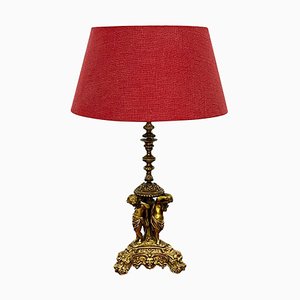 Lámpara de mesa de bronce dorado con Putti musical