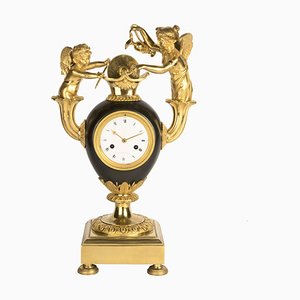 Horloge Cupidon Empire en Bronze Patiné et Doré