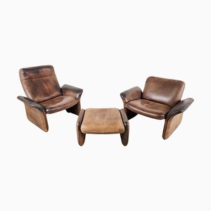 Vintage DS50 Leather Lounge Chairs and Ottoman from De Sede, 1970s, Set of 3