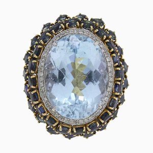Anello con topazio blu, diamanti, zaffiri e oro