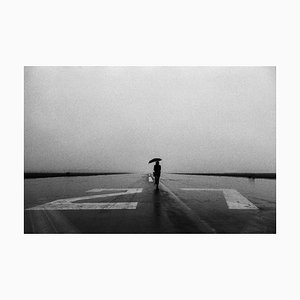 Tim Bieber, Lone Person with Umbrella in the Rain on Runway, Papel fotográfico