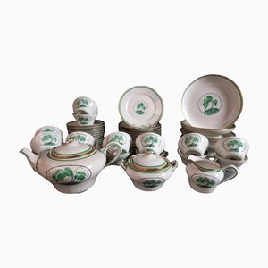 Juego de té y postre Art Déco de porcelana con decoración de palmera de Rouard. Juego de 47