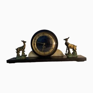 Reloj Art Déco de mármol, bronce y latón en una cajonera, años 30