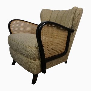 Sillón vintage con reposabrazos y trenzas vienesas