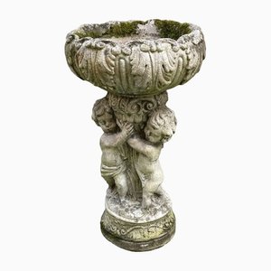 Vaso in pietra ricostituita con 3 putti