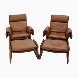 Sillones italianos Mid-Century de cuero con otomanas, años 60. Juego de 4