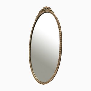 Espejo ovalado vintage de yeso dorado