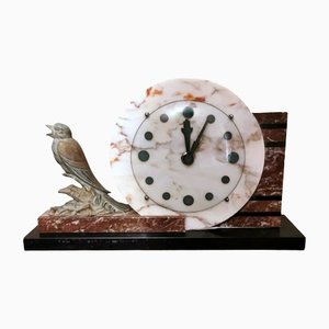 Reloj francés Art Déco de mármol y pájaro de metal bronceado, 1930