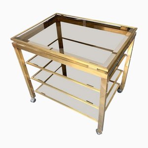 Bar Trolley in Gilt Metal with 4 Smoked Glass Shelves in the style of Guy Lefevre, 1970s