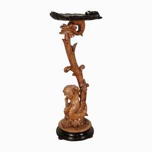 Pedestal "Eros montando un delfín" de madera natural y madera ennegrecida, finales del siglo XIX