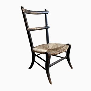 Antique Fireside Chair with Ebonised Finish and Rush Seat
