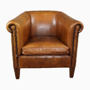 Club chair in pelle di pecora color cognac