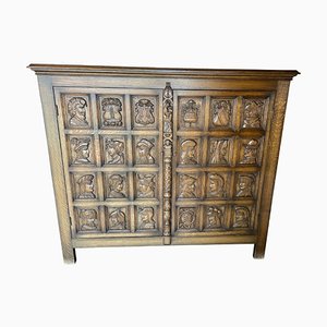 Antique Cabinet with Carved Coats of Arms and Heads on the Front