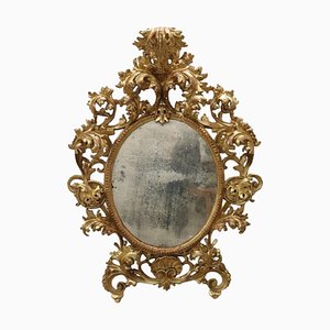 Specchio da parete ovale in legno intagliato e dorato, XVIII secolo