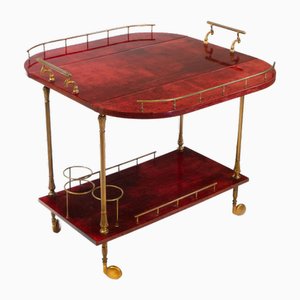 Carrello per bevande laccato rosso in pergamena e metallo dorato di Aldo Tura per Tura Milano, anni '50