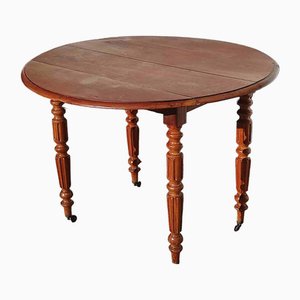 Mesa vintage redonda de madera con laterales plegables