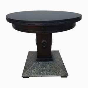Black Round Table on a Leg Covered with Pressed Brass Sheet. 1920s