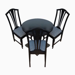 Tavolo e sedie rotondi in ottone sbalzato nero, anni '20, set di 4