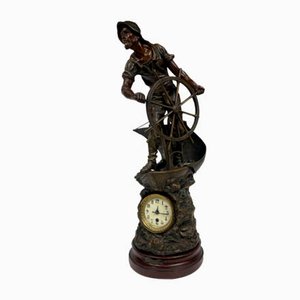 Reloj estatuilla francés de metal con marinero al timón de Xavier Raphanel