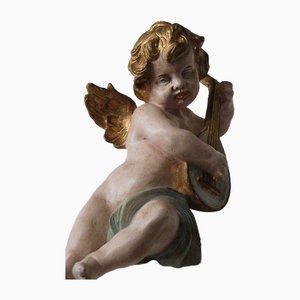 Figura de ángel de madera tallada con arpa