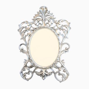 Specchio ovale in argento dorato con cornice rococò