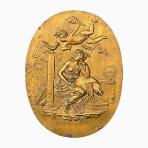 Medallón de bronce decorado con tema femenino y Cupido, siglo XIX