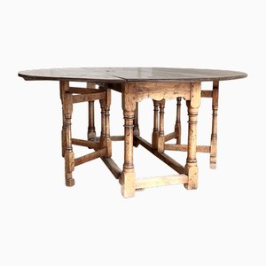 Solid Oak Dining Table with Folding Mechanism and Turned Legs, 1900s