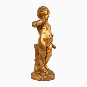 Escultura antigua de madera tallada y dorada que representa un Putto en actitud alegre, Florencia, siglo XIX