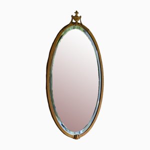 Espejo ovalado con marco dorado
