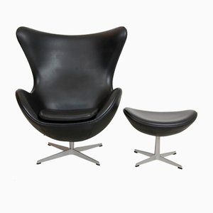 Egg Chair with Footstool in Black Leather by Arne Jacobsen, Set of 2