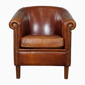 Club chair in pelle color cognac