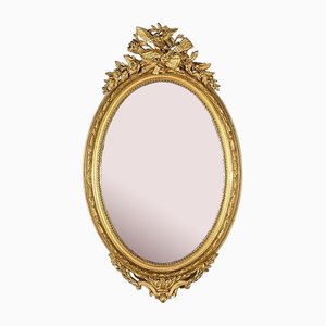 Espejo Luis XVI oval de madera dorada de finales del siglo XIX