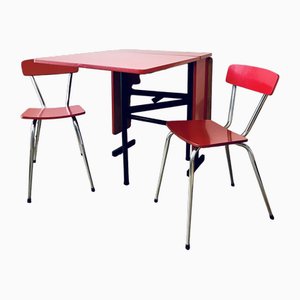 Mesa de comedor y sillas Mid-Century de formica roja, años 50. Juego de 3