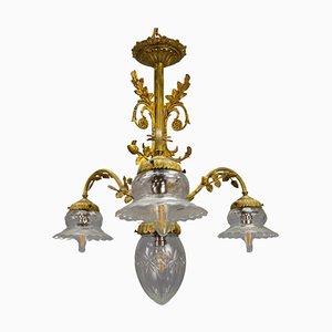 Lámpara de araña francesa estilo Luis XVI de bronce y vidrio claro, años 20